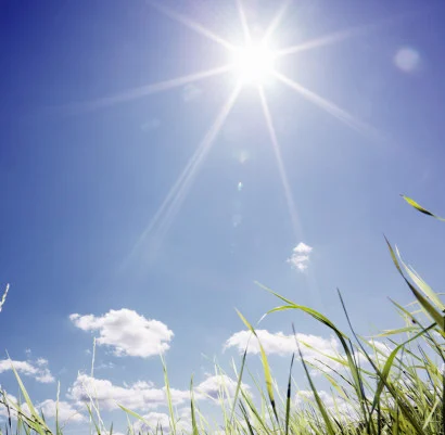 The sun in a blue sky.