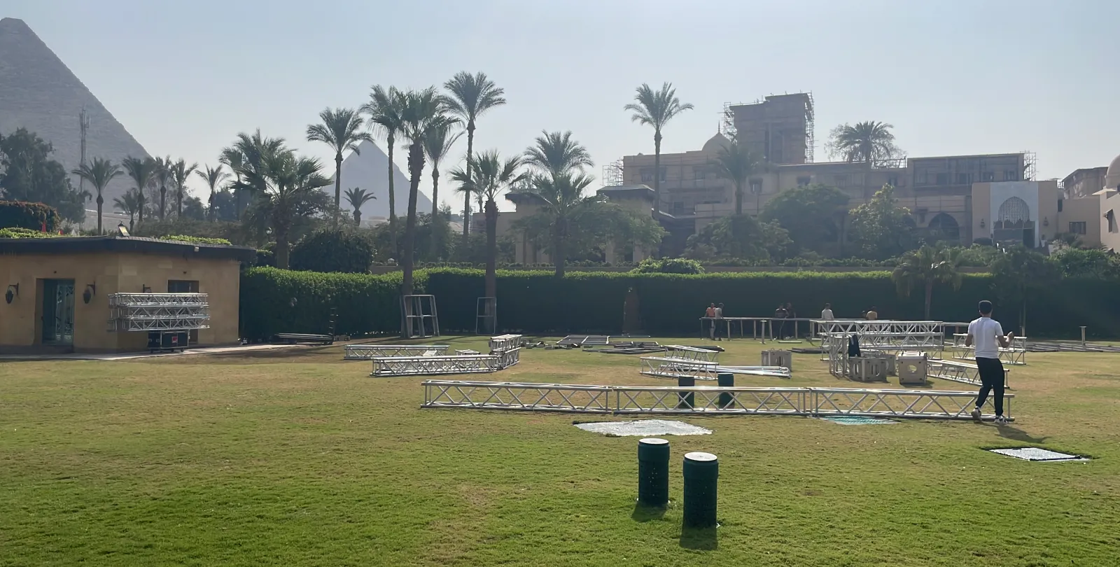 The same lawn, more truss sections and stage decks laid out on the grass.