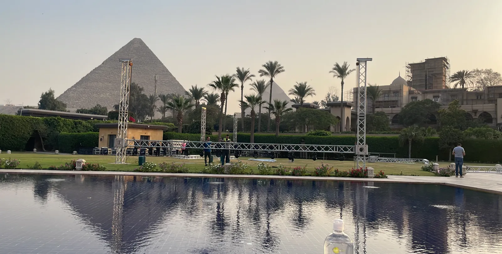 Late afternoon: the truss towers and the pyramid reflected in the hotel pool.