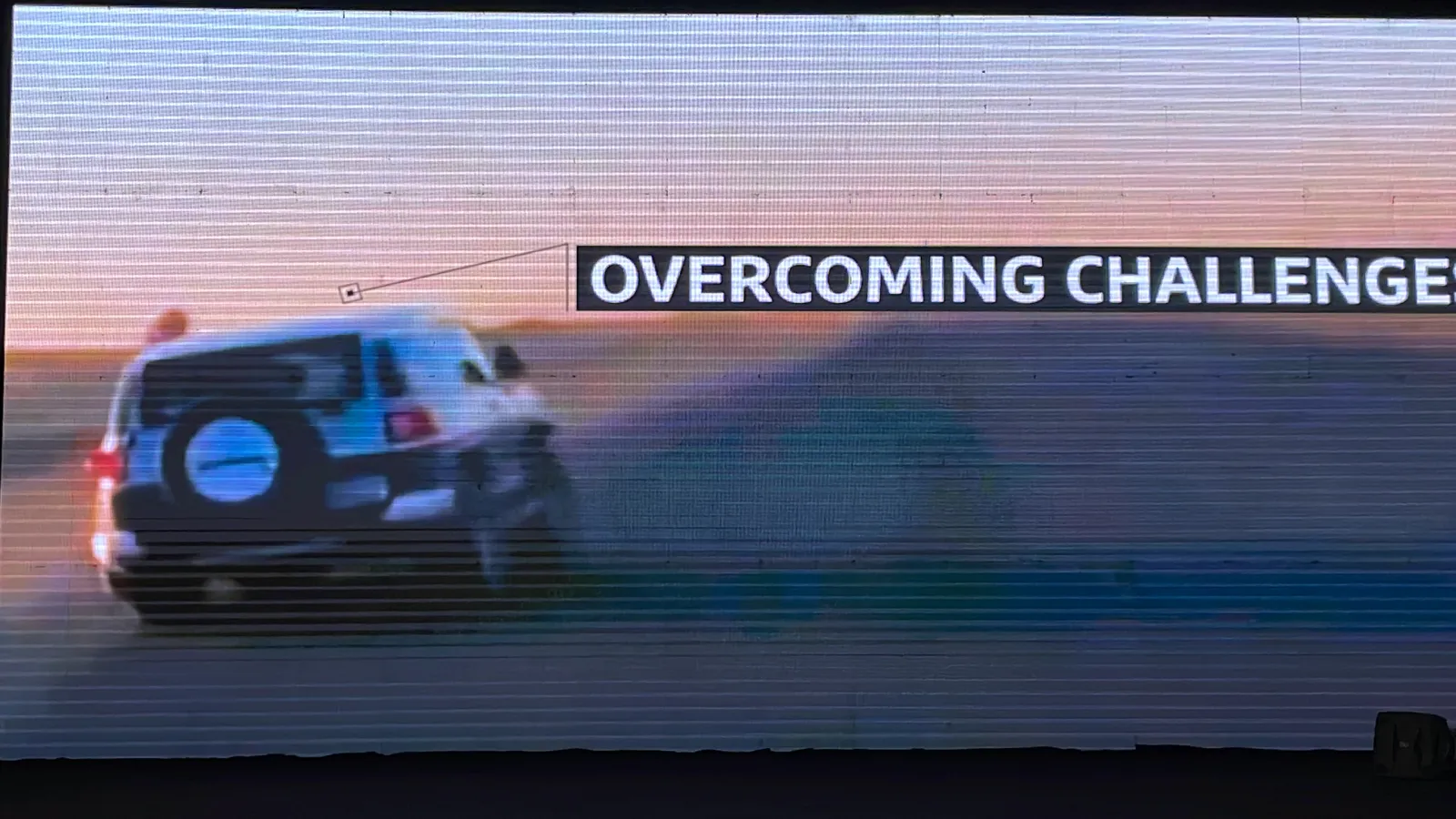 The LED wall showing the same 4x4, labelled Overcoming challenges.