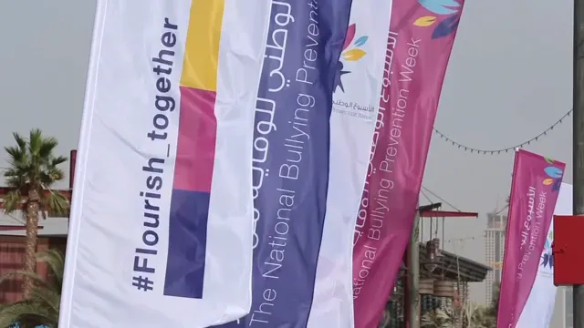 Feather flags reading #Flourish_together