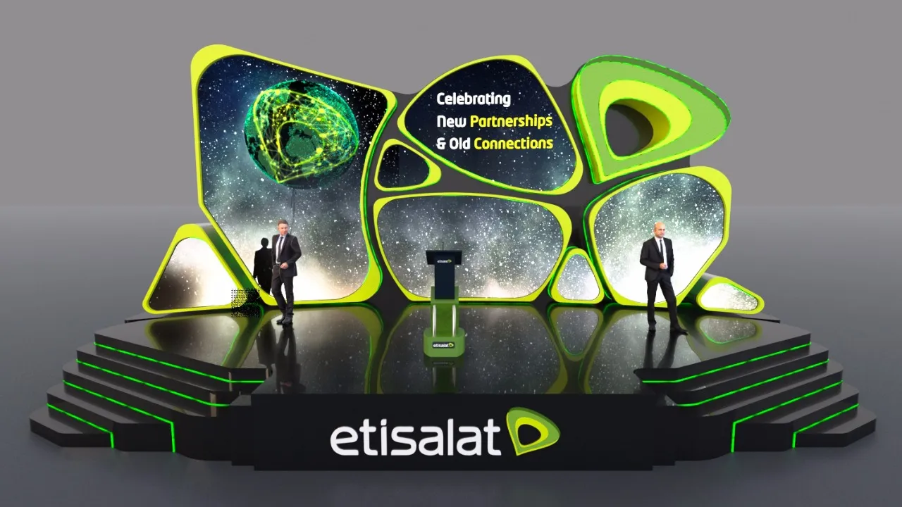 Render: a stage of screens shaped like cells, each in a bright green rim, showing a starry sky, the line Celebrating New Partnerships and Old Connections, and the Etisalat mark; etisalat on the stage front